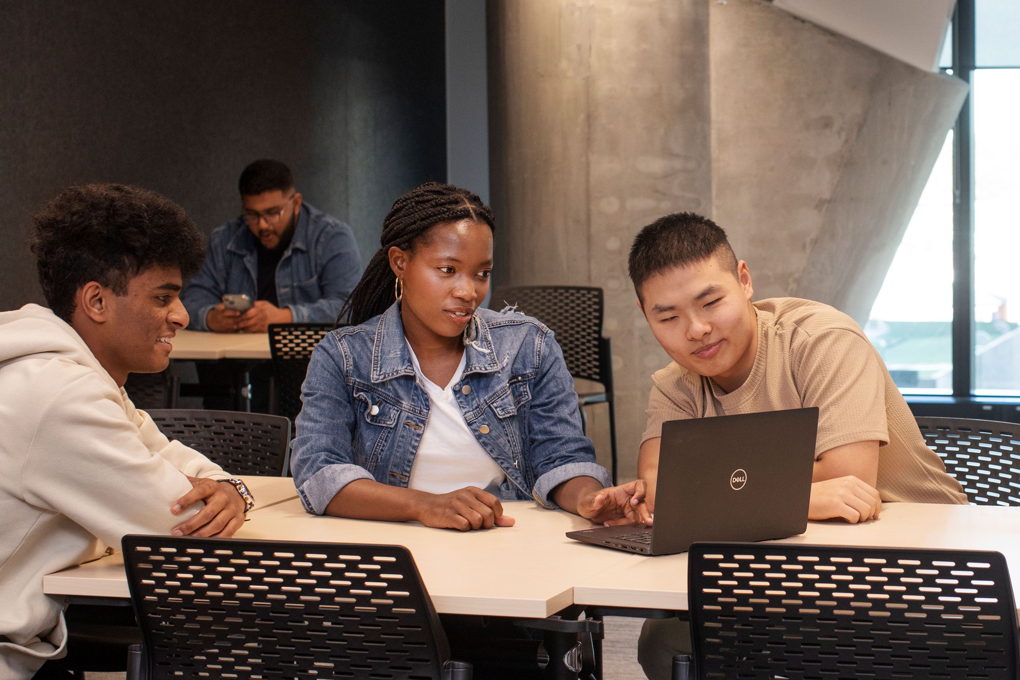 students at a desk with a laptop