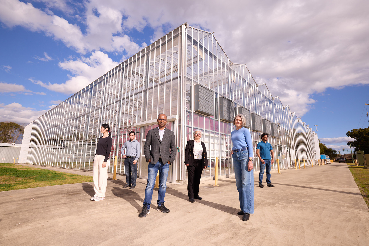 Researchers out the front of a facility